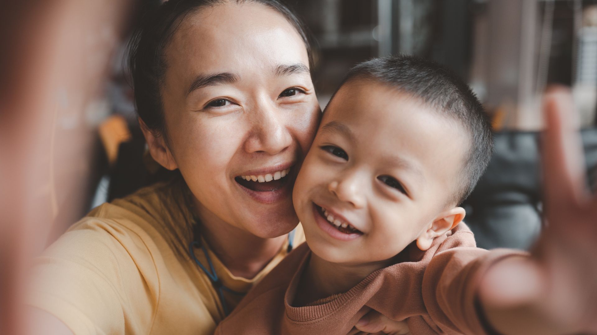 Smiling woman and child taking a selfie.